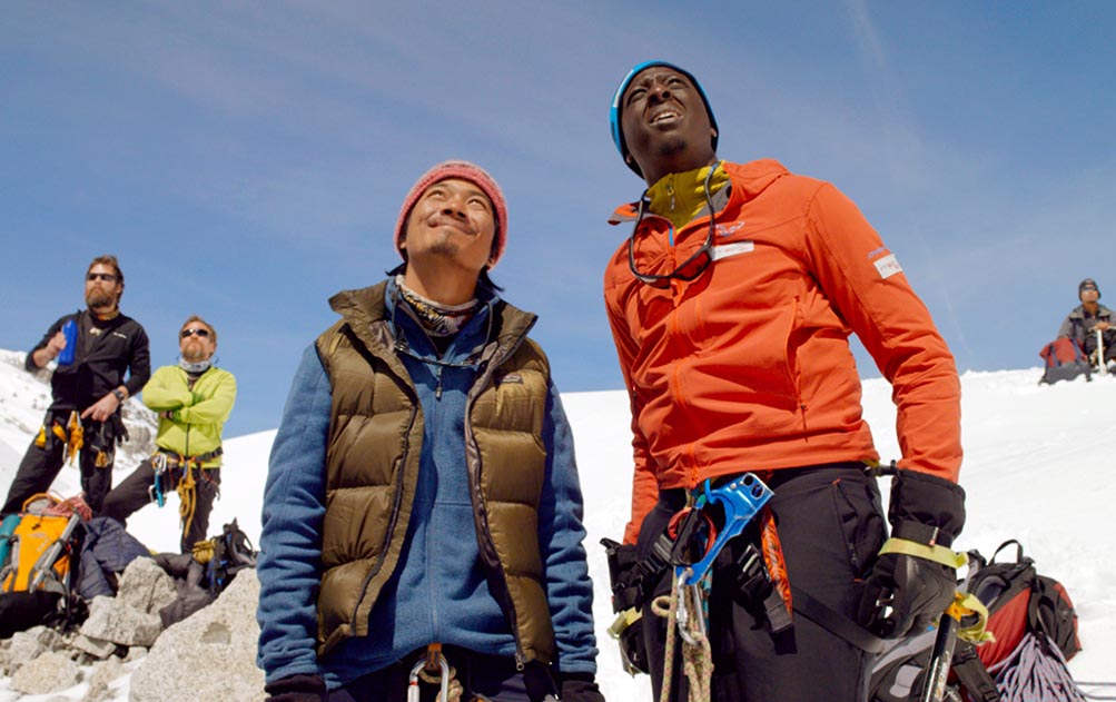 Samy and his guide looking up at a wall of ice in The Climb film