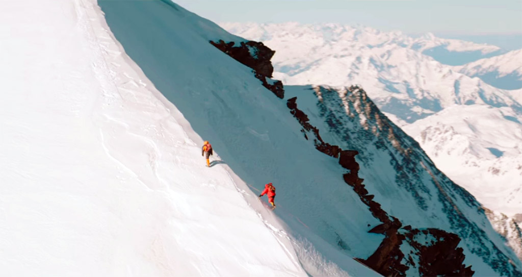 Samy and guide walking up the snowy side of Everest in the film, The Climb